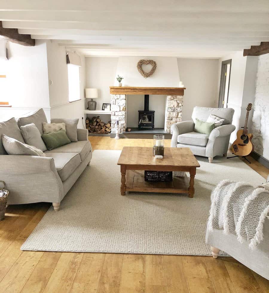 Spacious country living room with stone fireplace and guitar