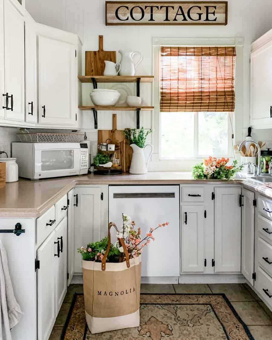 Charming cottage kitchen with white cabinetry and bamboo shades