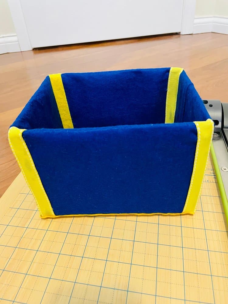 Homemade storage bin with yellow ribbons