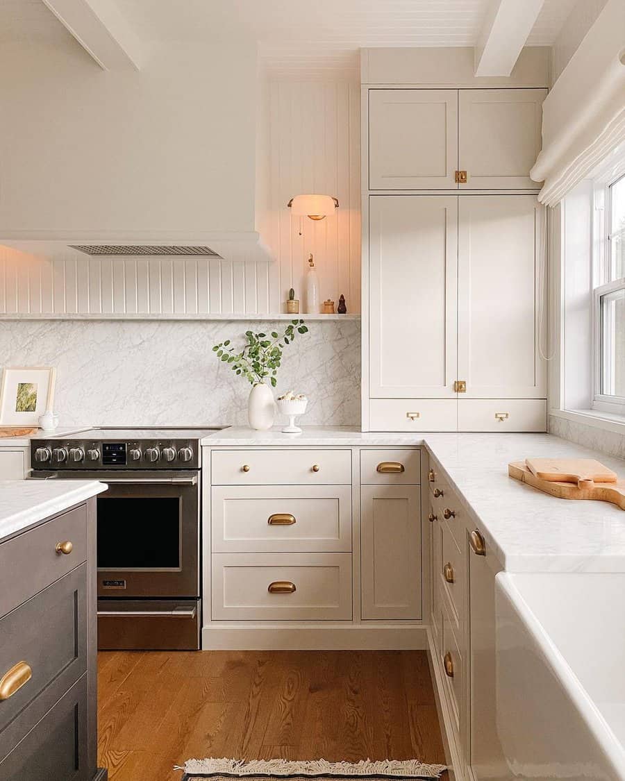 White kitchen cabinets with gold metalware
