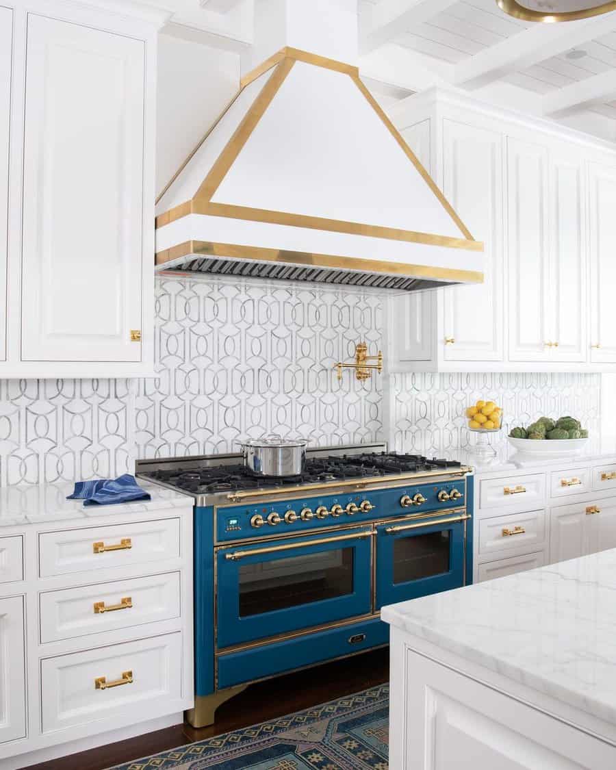 White kitchen cabinets with gold metalware