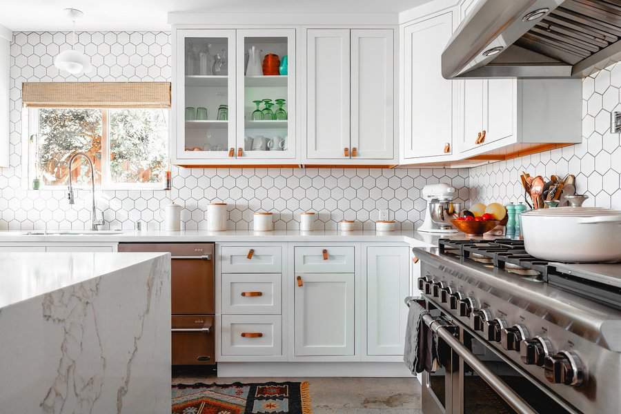 White kitchen cabinets with gold metalware