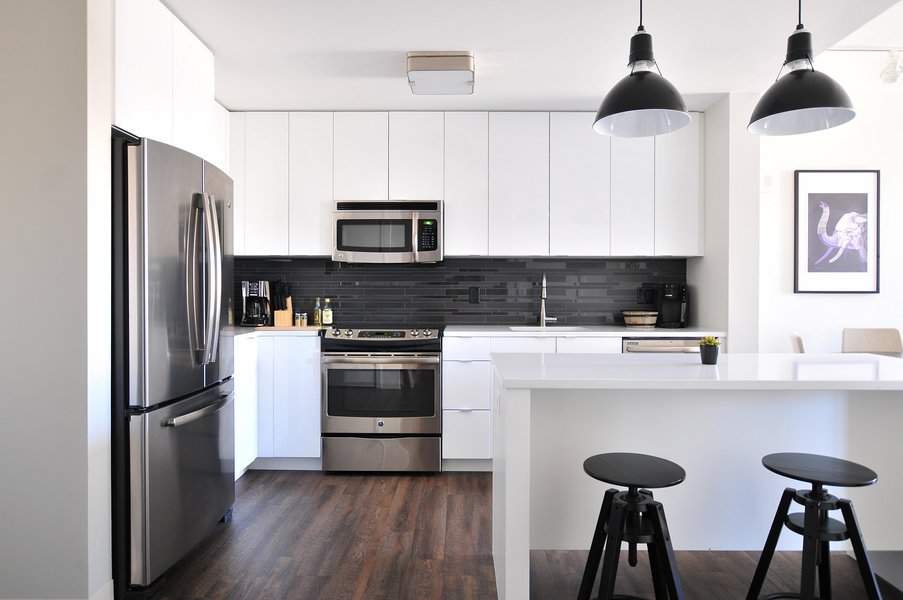 White cabinets with black backsplash