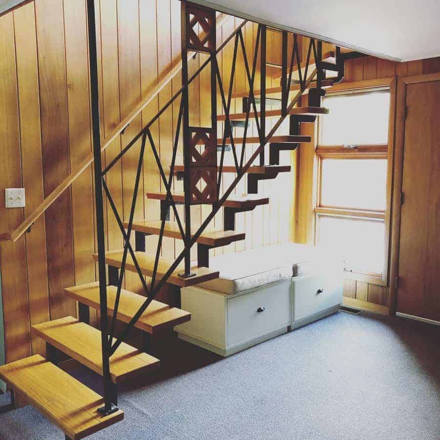 Wooden staircase with a metal railing