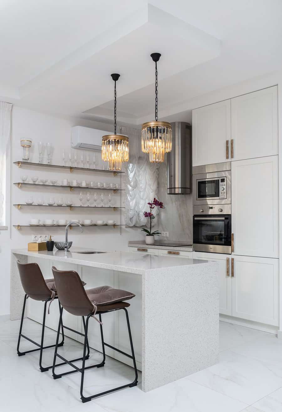 White kitchen cabinets with gold metalware