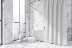 oval white ceramic bathtub with a curtain
